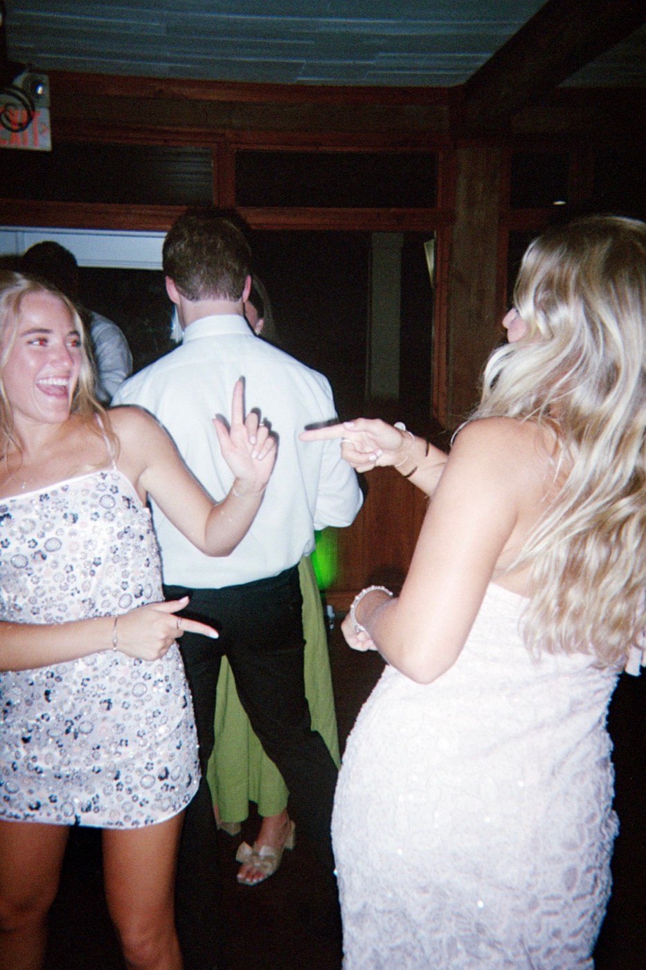 Bridesmaid and groomsman dancing together, laughing