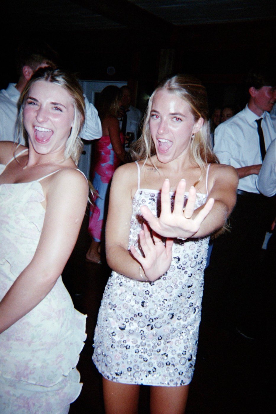 Two guests laughing together on the dance floor