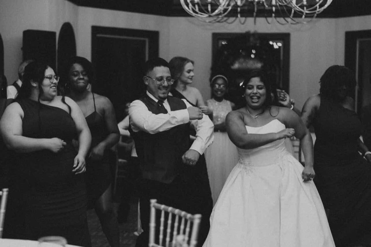 Wedding party dancing together in a joyful circle