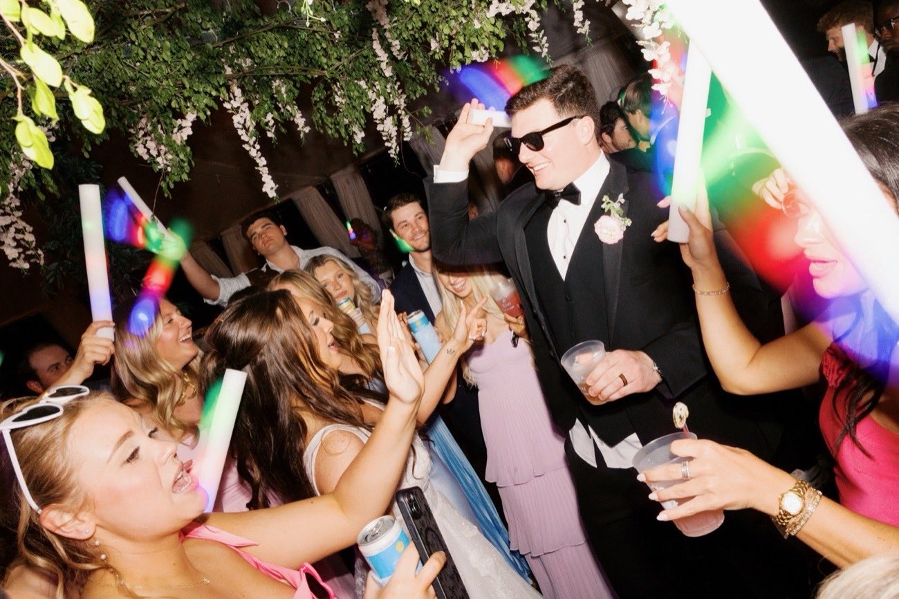 Wedding guests dancing with LED foam sticks at an Akanbi Entertainment reception